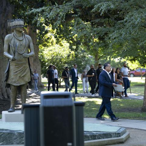 walking past statue