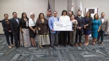 Big check group photo with Assemblymember Ramos, students, college officials, electeds, and tribal leaders.