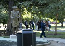walking past statue